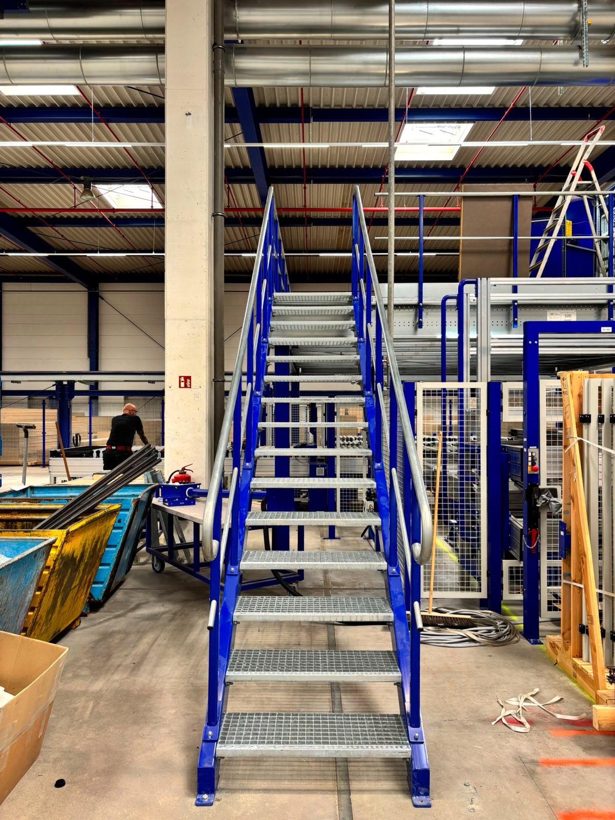Steel access staircase with railings leading to the mezzanine floor — Ballerina-Küchen, Rödinghausen