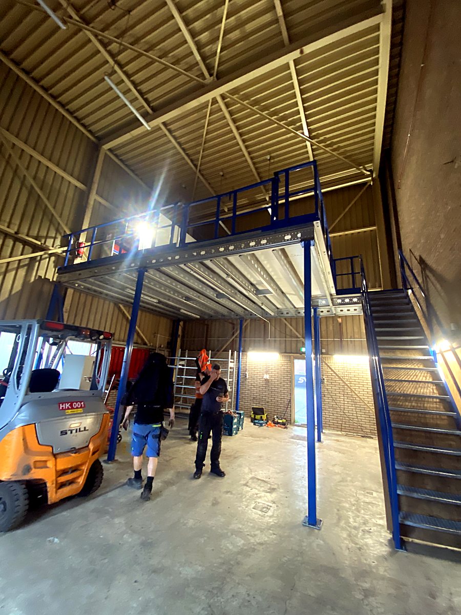 Northex installers beneath the completed mezzanine with staircase — Royal IHC B.V., Kinderdijk