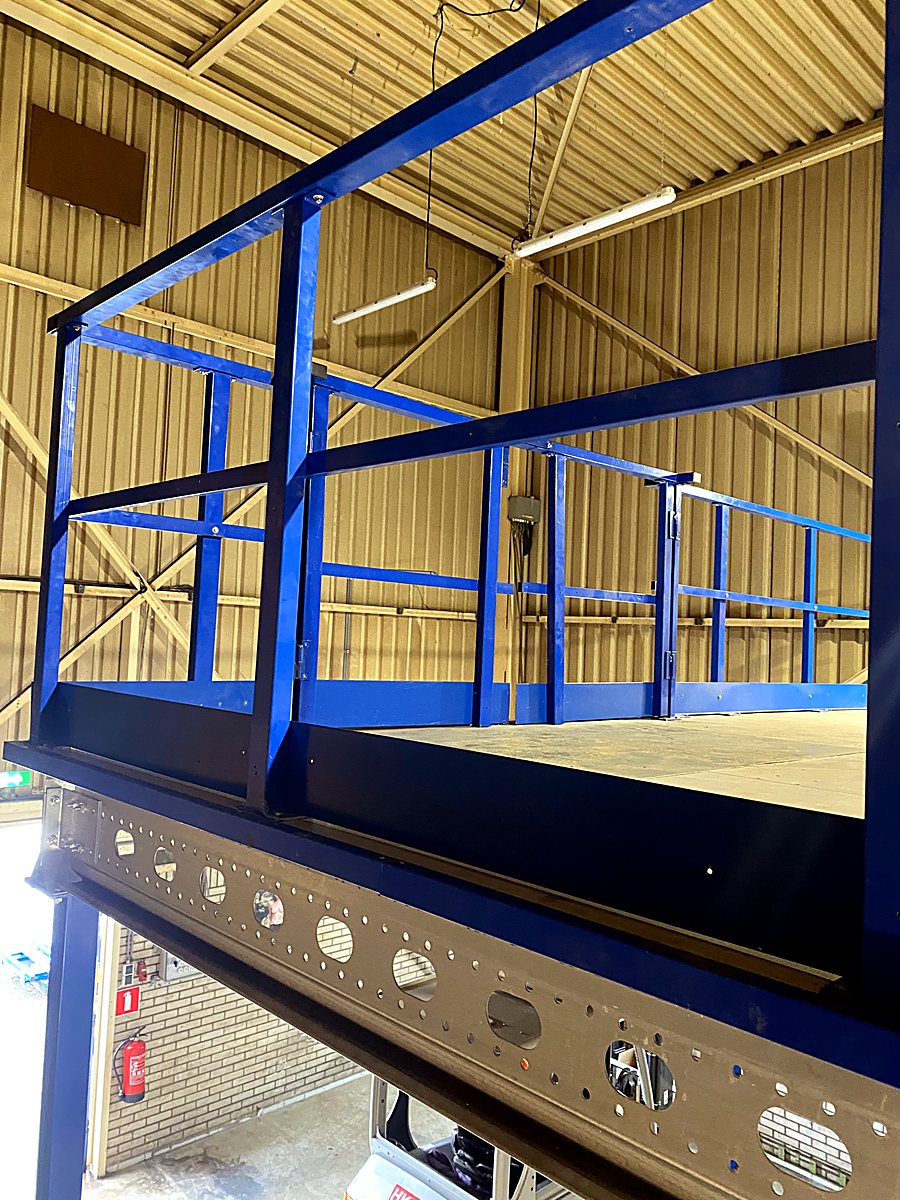 Detail of the blue railings and mezzanine beam — Royal IHC B.V., Kinderdijk